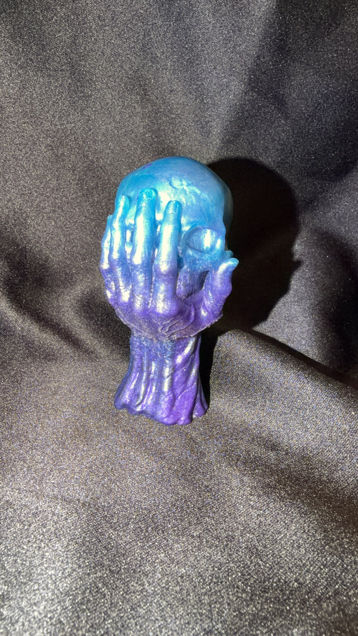 Blue and Purple Skull in Hand