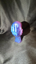 Blue and Pink Skull in Hand