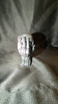 Black and Pink Skull in Hand