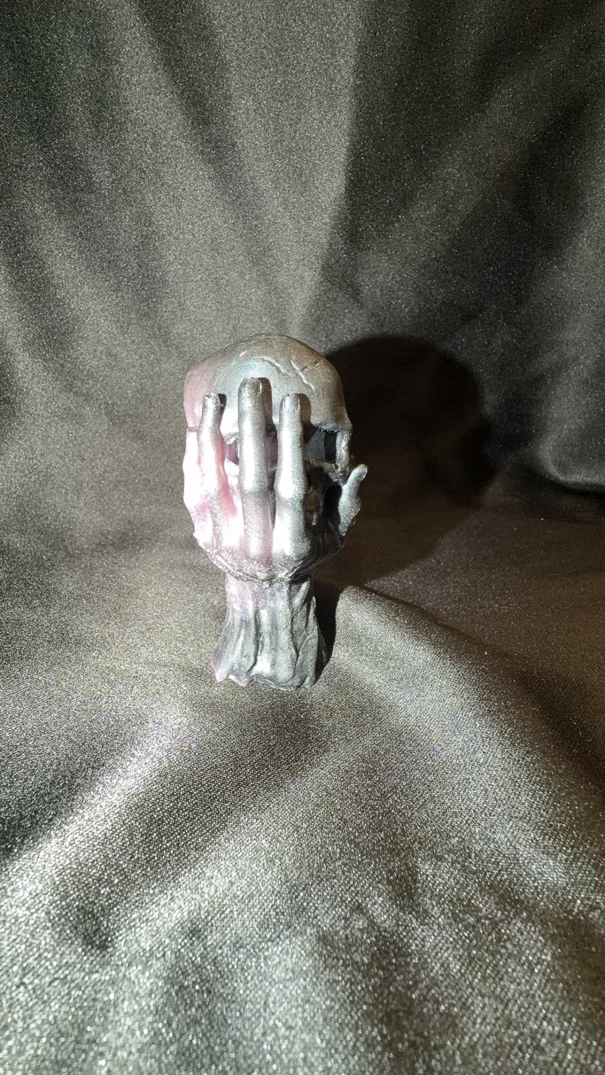 Black and Pink Skull in Hand